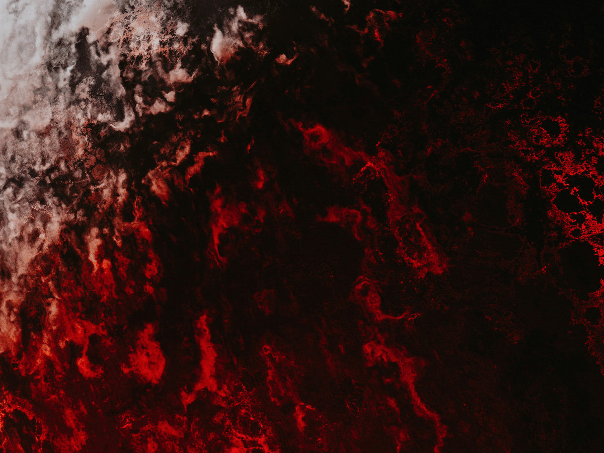 Red lit rock against black