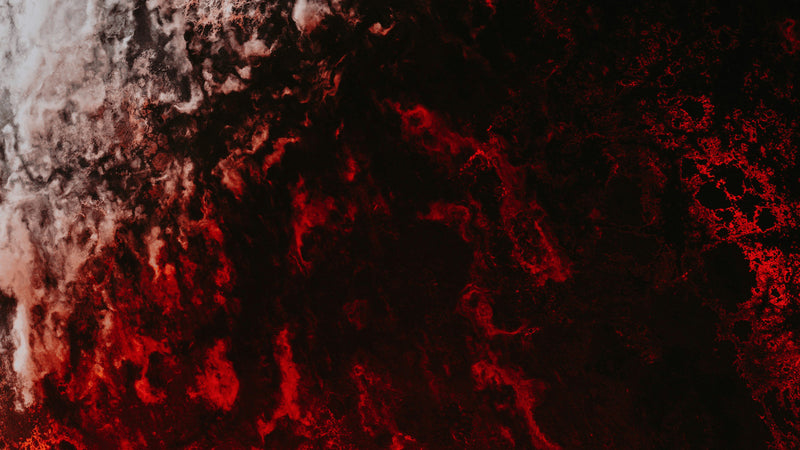 Red lit rock against black