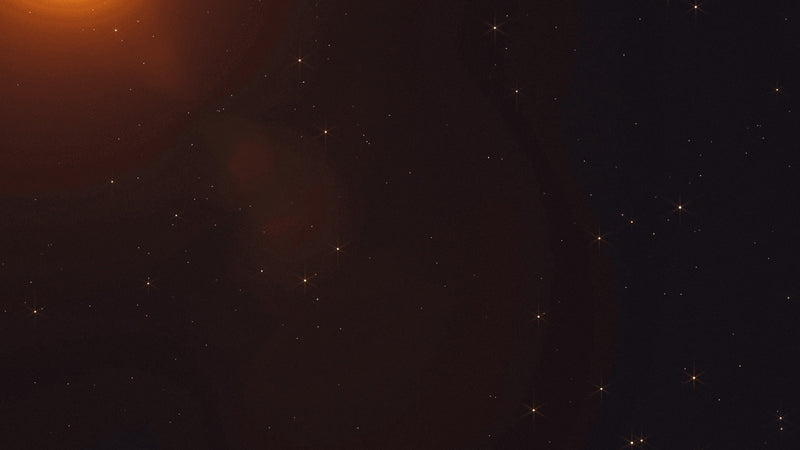 An orange glow above a dark field
