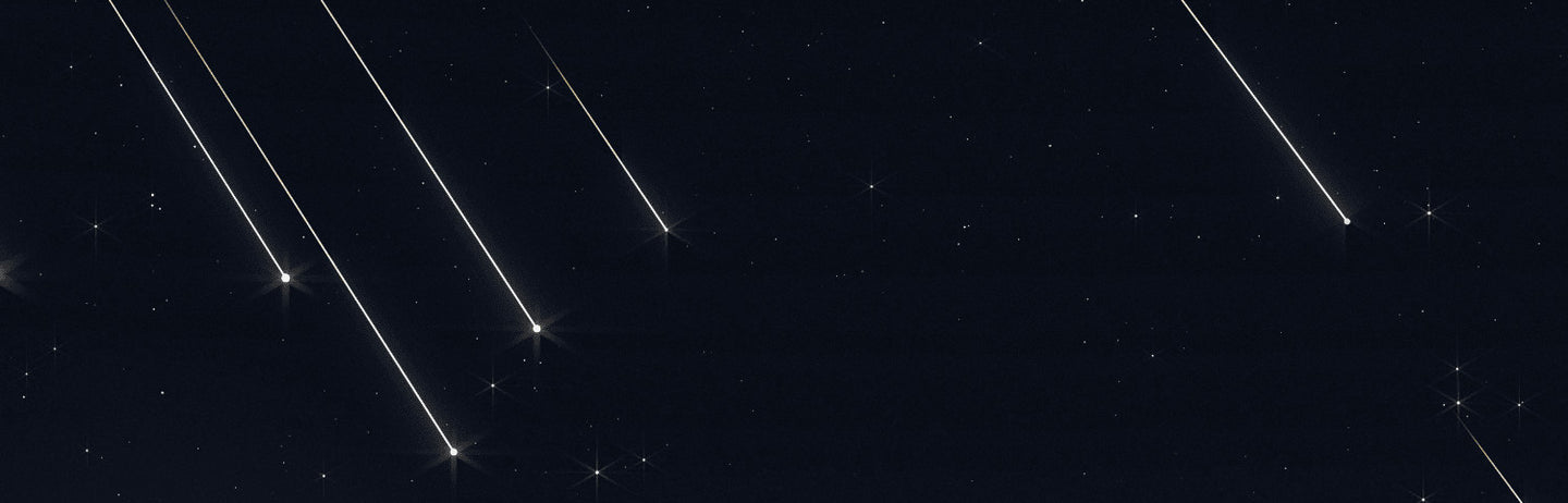 A crescent moon with meteor trails