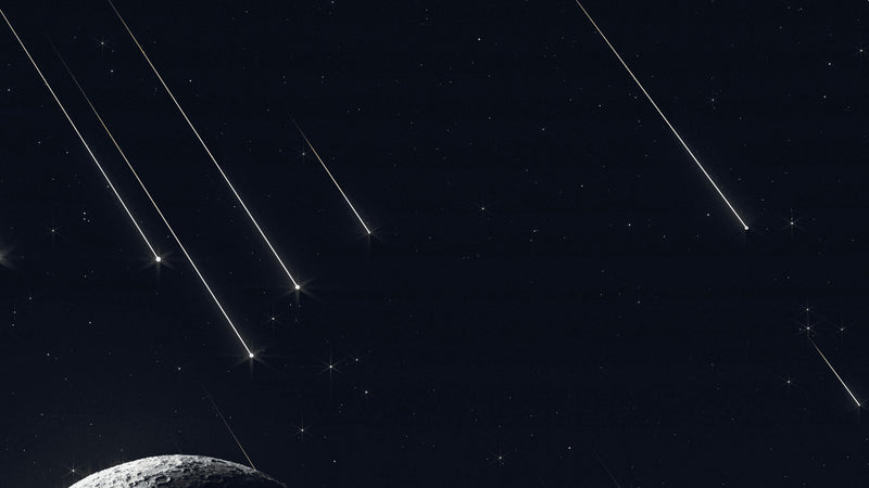 A crescent moon with meteor trails