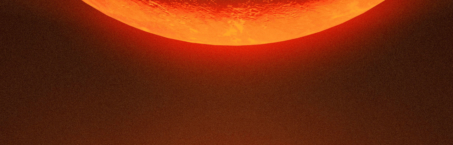 An orange crescent glowing above a black field