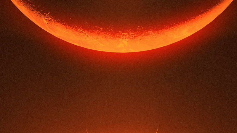An orange crescent glowing above a black field