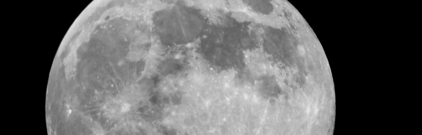 A full grey moon on black