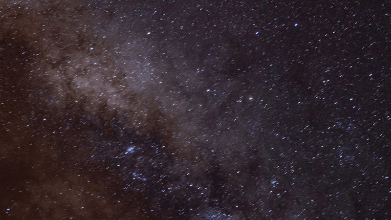 A starfield with a faint violet cloud