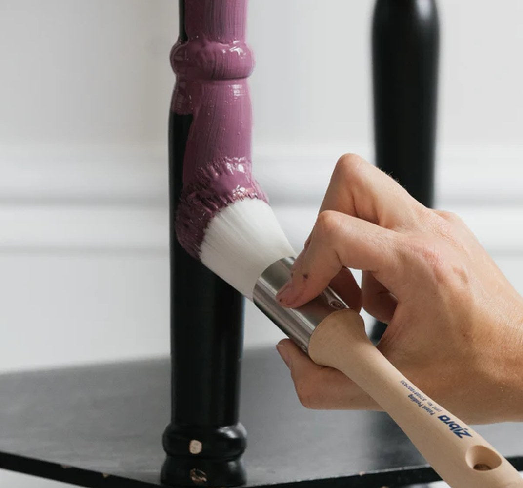 A Zibra paintbrush has been used to hand paint a chair leg.