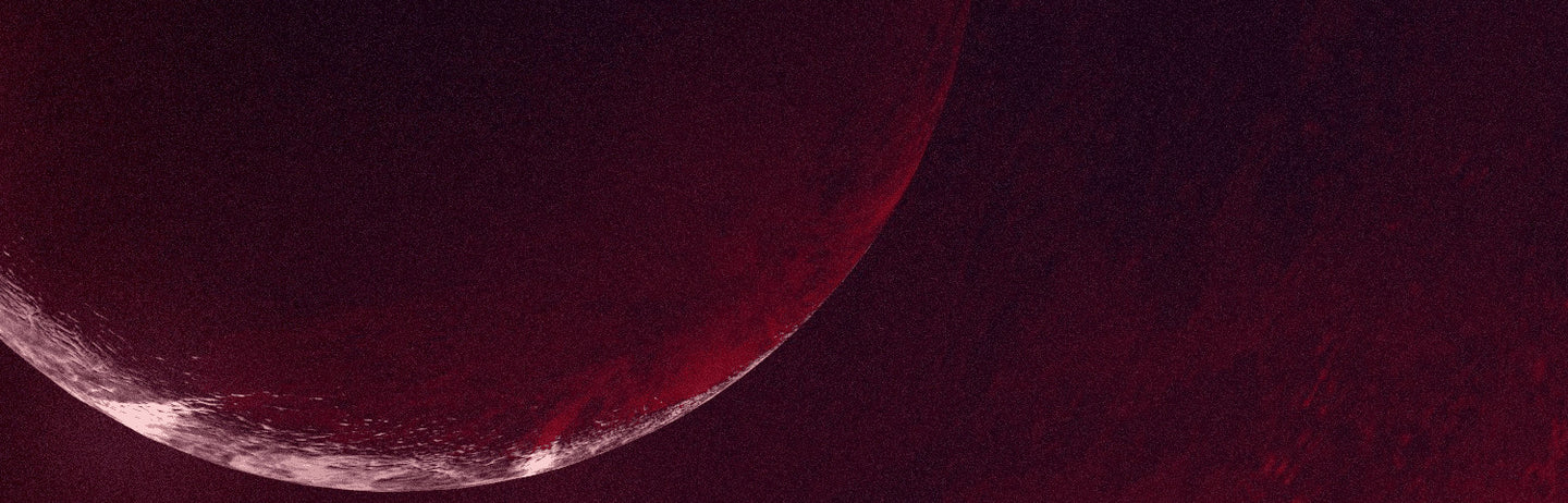 A dark red planet on a crimson sky
