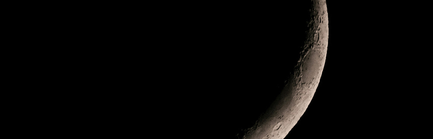 A white crescent moon on black
