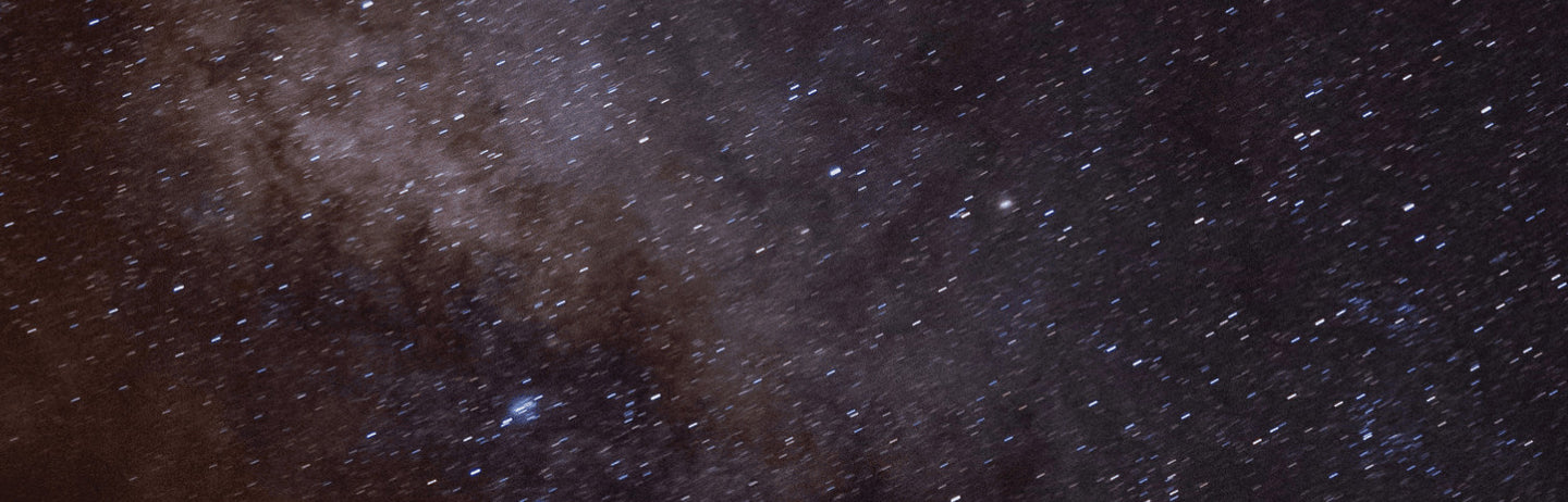 A starfield with a faint violet cloud